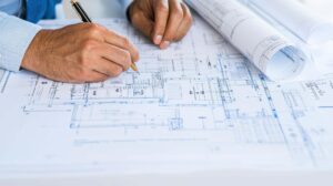 Engineer reviewing blueprints — engineering consultants in Vadodara